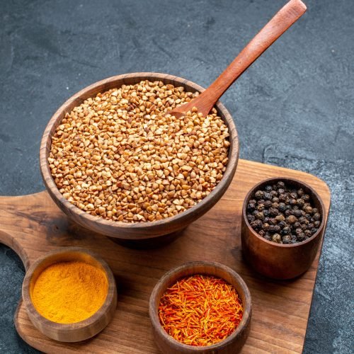 top-view-raw-buckwheat-with-seasonings-dark-grey-space